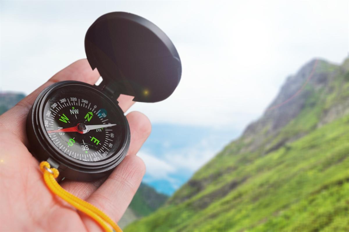 Compass in hand pointing the way.